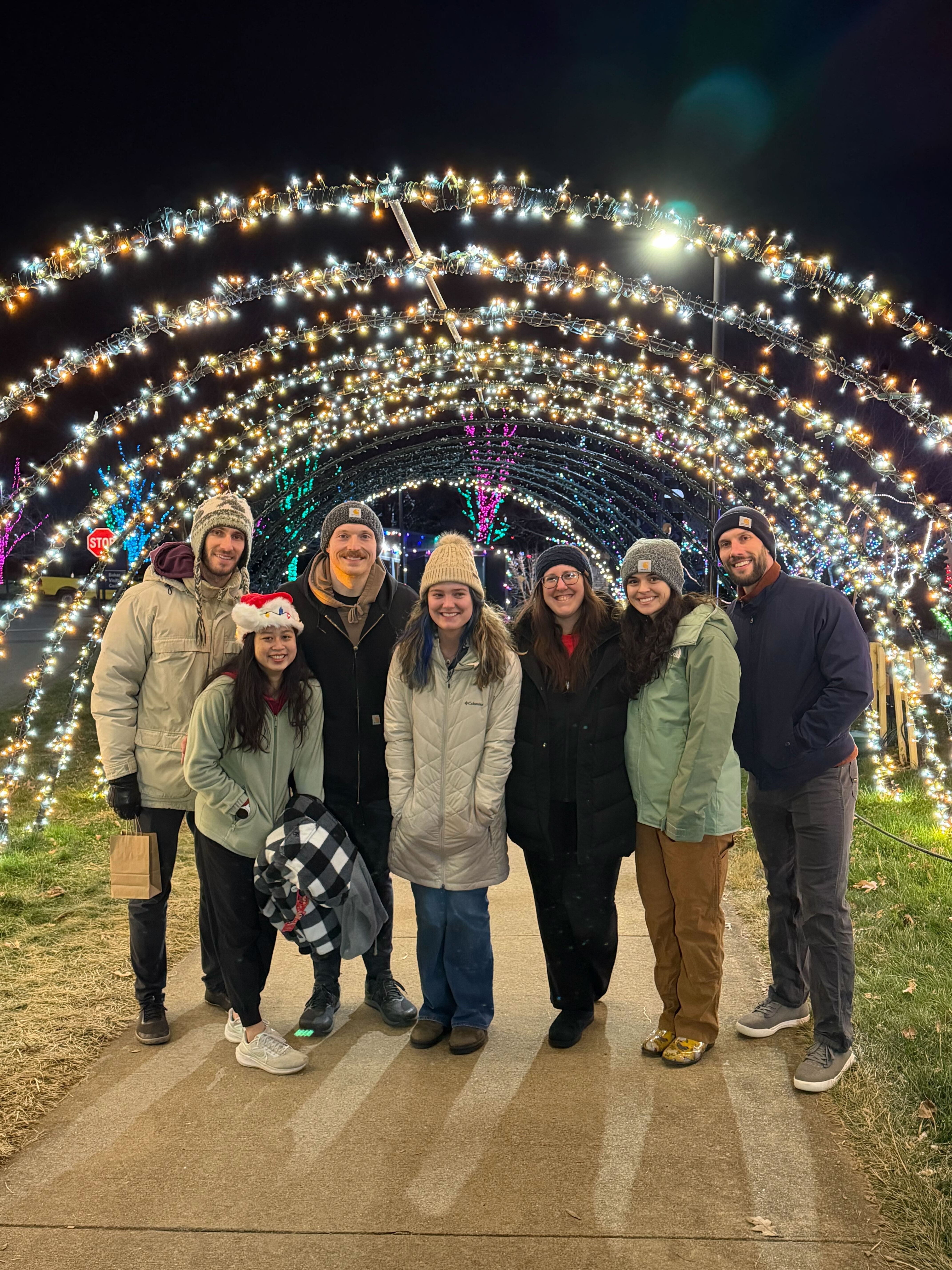 A lone figure casts a long shadow on the beach.
