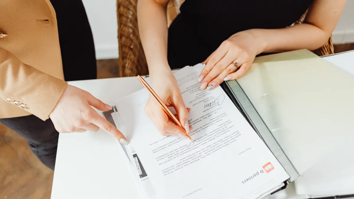 grayscale photo of man walking on road