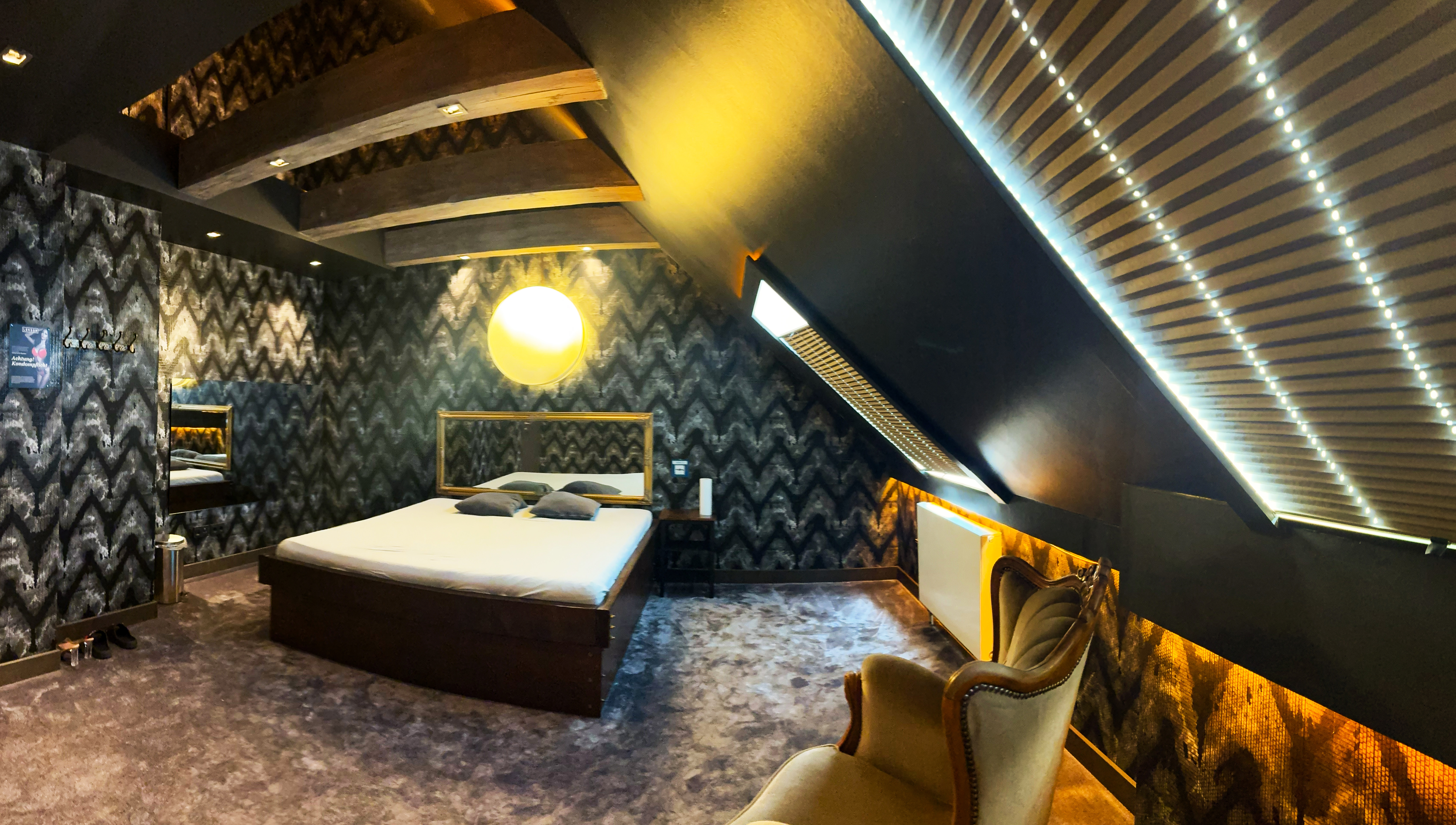 Elegantes Zimmer der Villa Amore Düsseldorf mit Doppelbett, warmem Licht und privater Atmosphäre