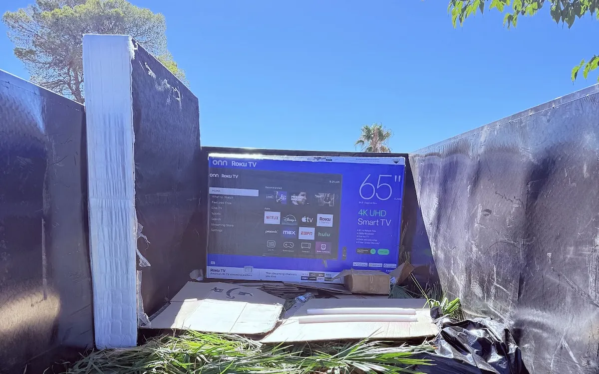 Old TV loaded into a trailer for removal