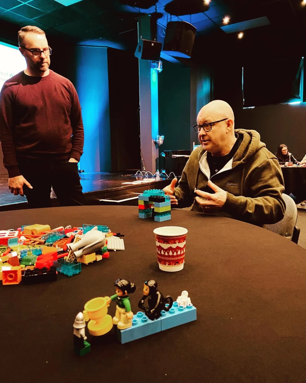 Julian Clark discussing a Lego Serious Play sessions with a Leader at a Leadership Workshop