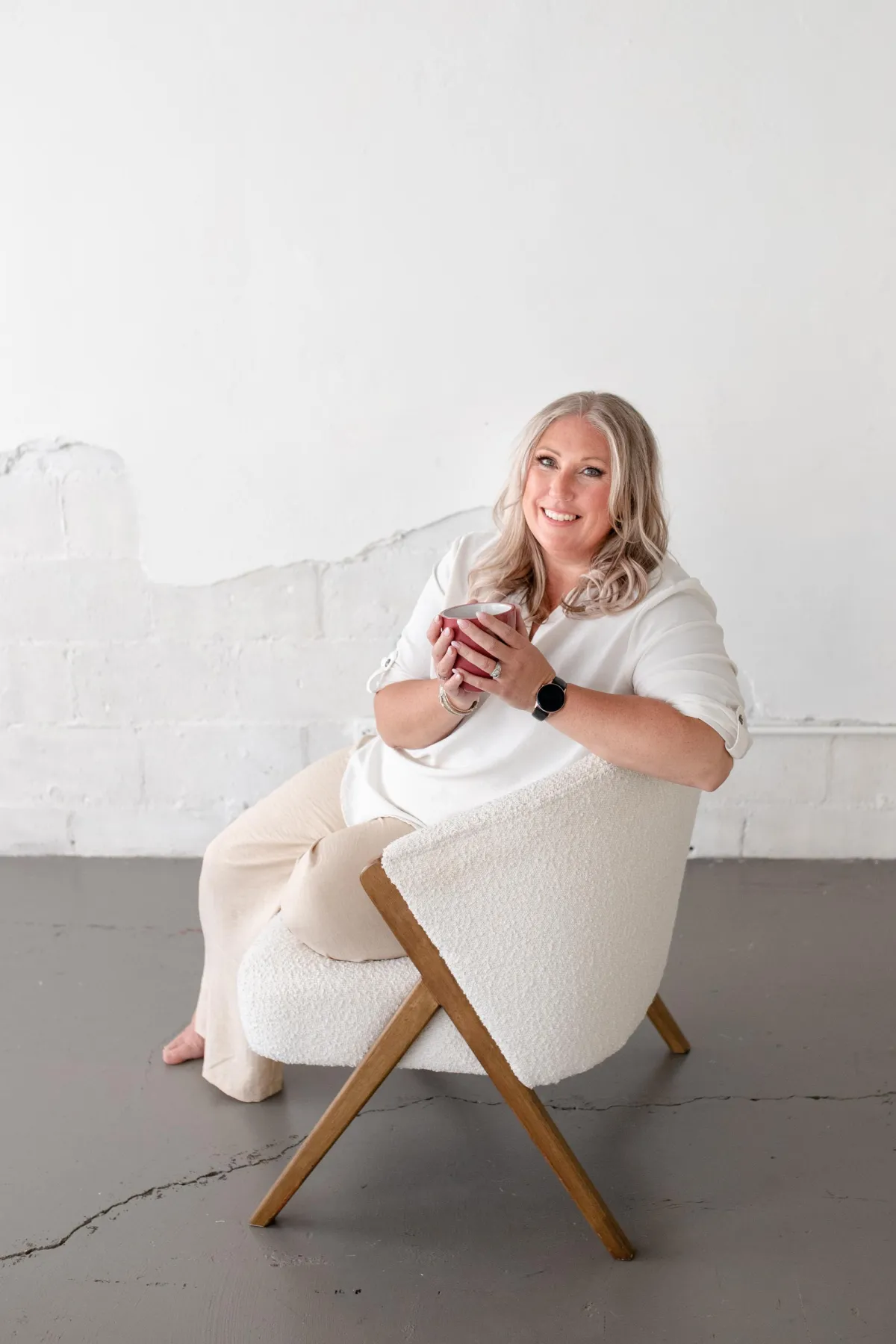 Kristyn sitting with a coffee in fresh and clean scene