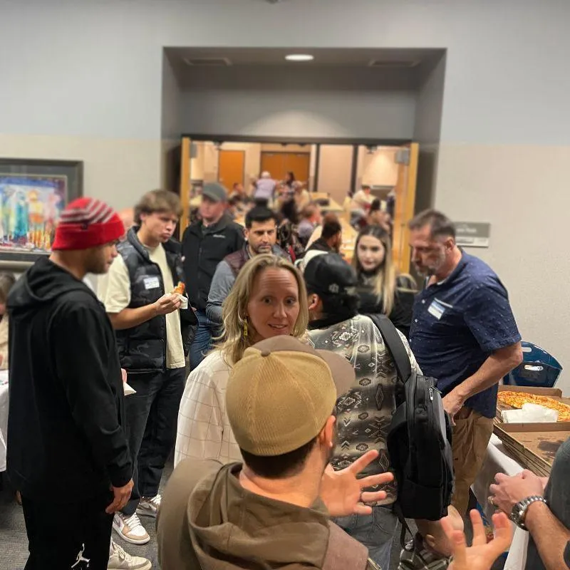 Real estate investors networking at a live Utah REIA event, building connections and discussing investment opportunities