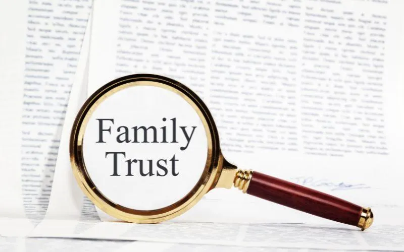 Image of magniying glss focusing on Family Trust  dcument