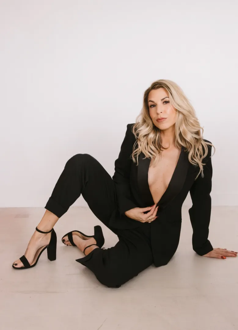 Mandi Neuhardt, founder of Beauty Brigade Concierge, dressed in an elegant black suit