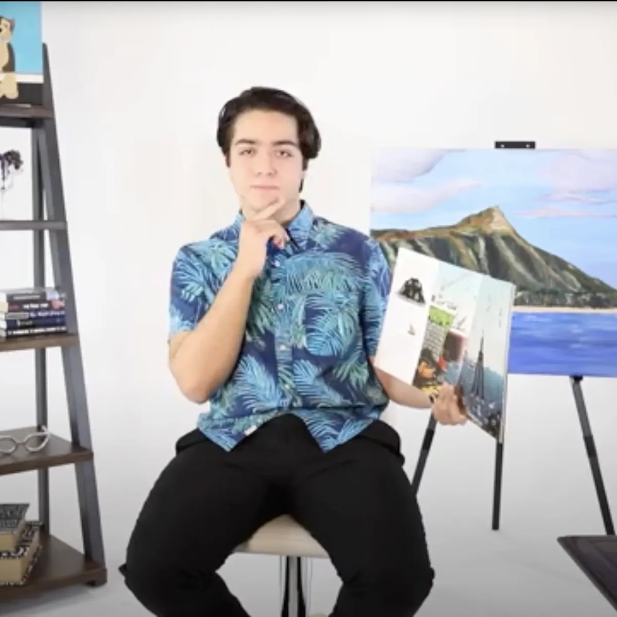 Man talking to camera with a book. 