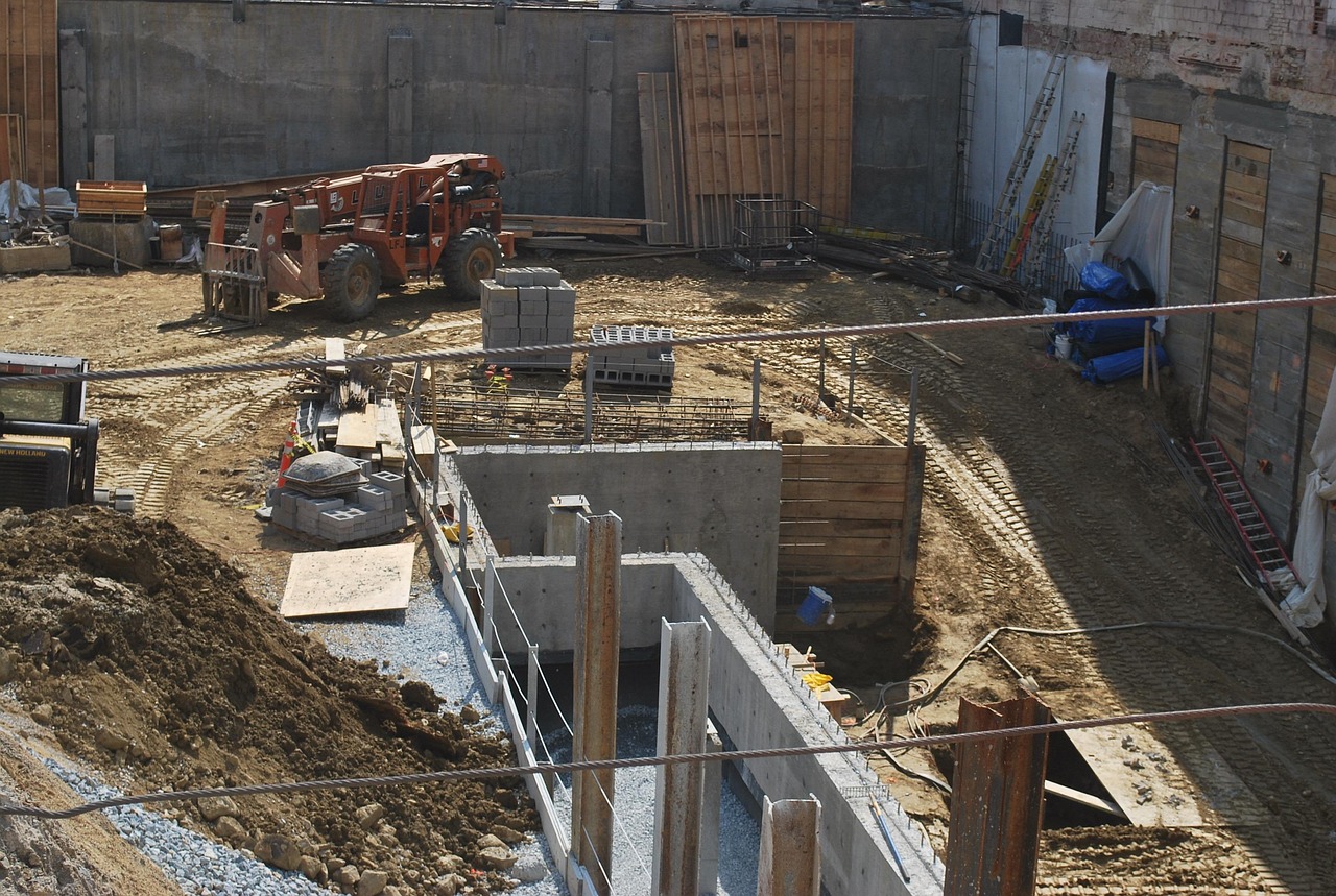 a construction jobsite with concrete foundation walls poured.