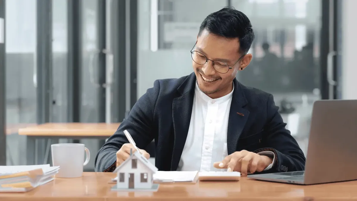 Close-up of a hand using a calculator over financial documents and billing statements, representing accurate claims accounting and back office support
