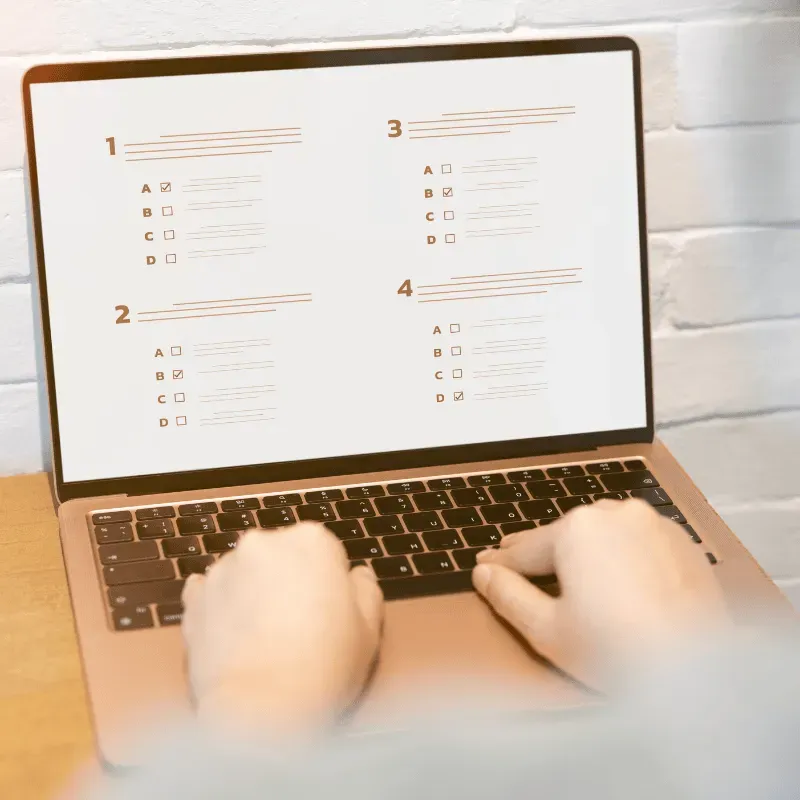 Person taking an online business assessment quiz on a laptop to identify gaps in restoration claims processes and cash flow