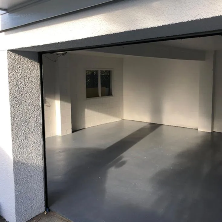 Painter applying fresh paint to interior walls in Auckland home