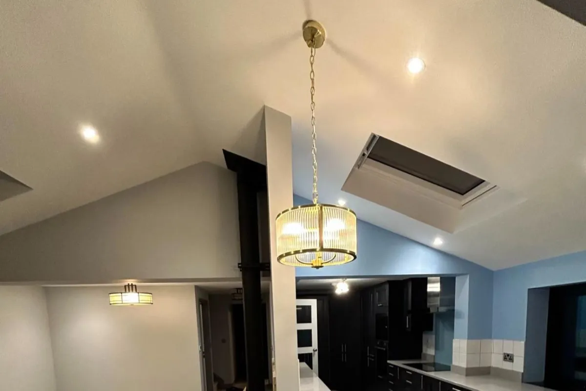 Lighting contractor in Oxford fitting LED downlights in a kitchen