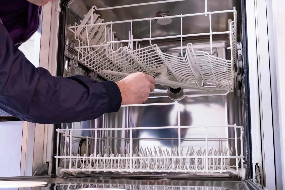 inside of dishwasher being repaired