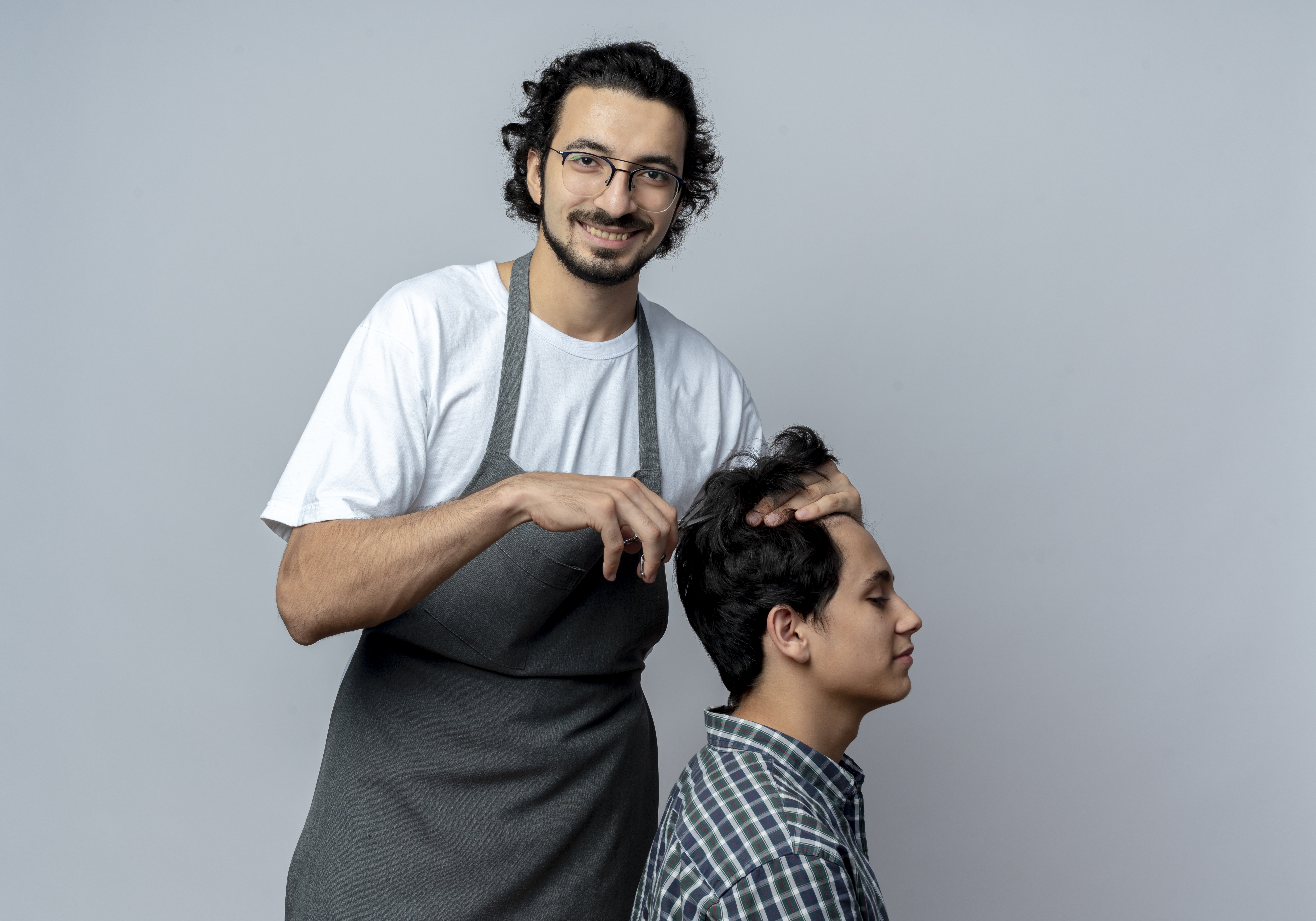 Licensed barber teaching haircut technique during barber instructor training in Columbus GA