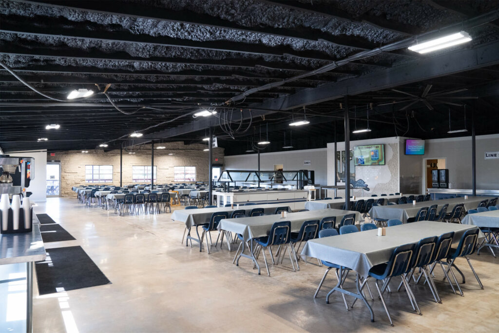 Dining hall at Feel Day 2025. Open area with some tables and chairs