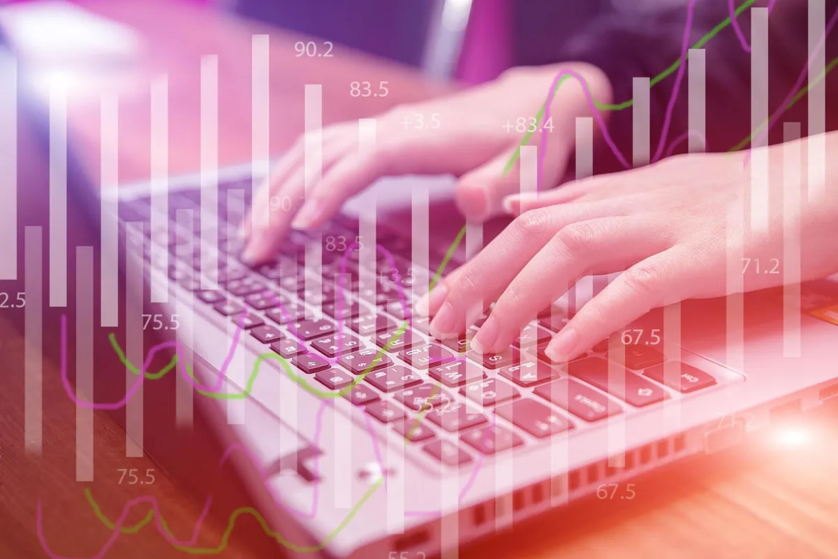 Hands typing with growth chart overlay, symbolizing scalable lead generation strategy