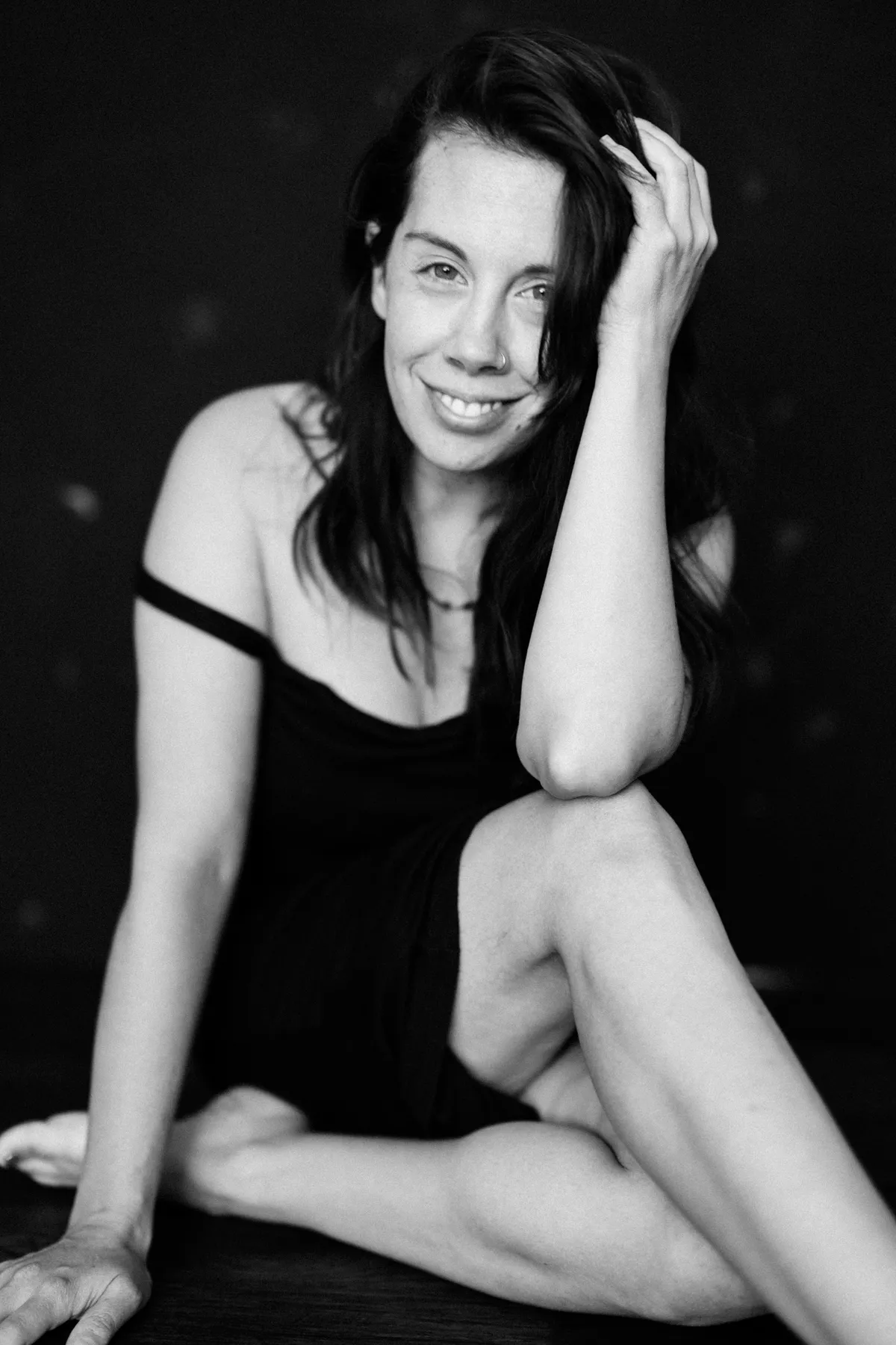 Elisa Mitchell, photographer, smiling in a black-and-white portrait.