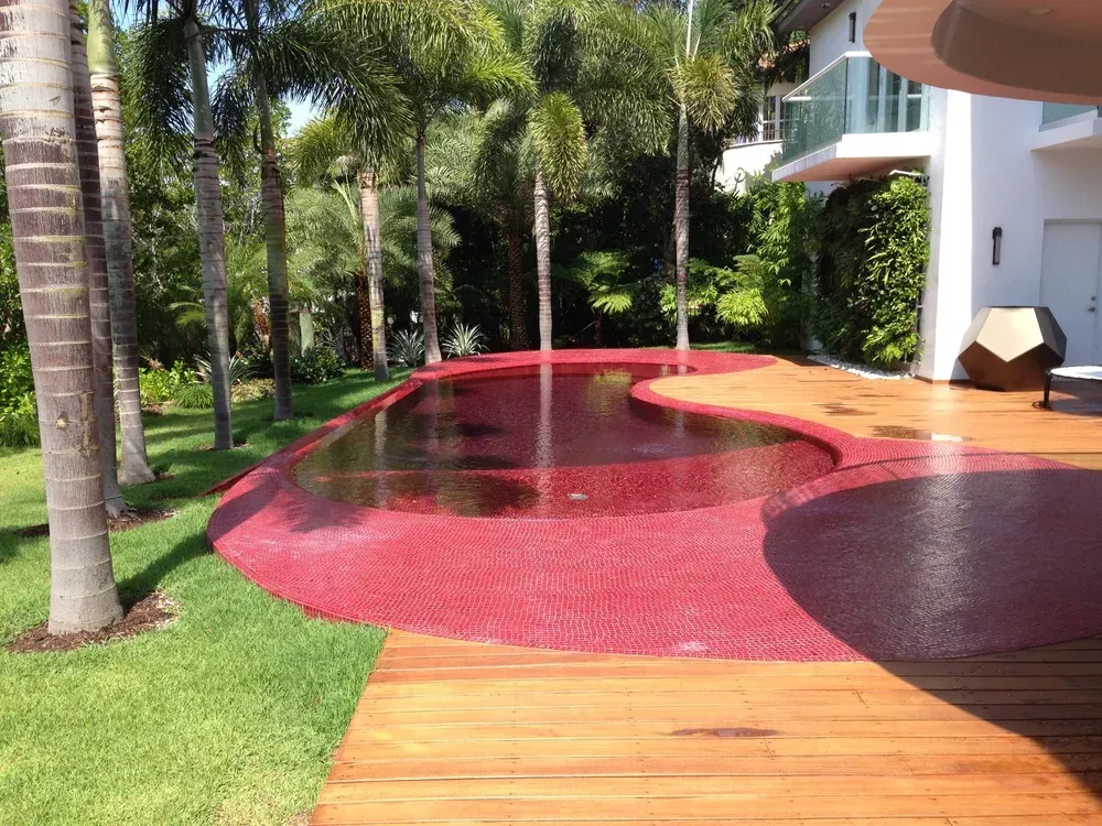 Unique custom pool design with decorative deck and palm trees - one-of-a-kind pool concepts by Gables Pool Miami