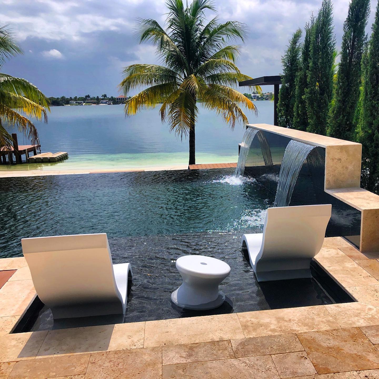 Completed luxury pool and modern home reveal - custom pool construction and implementation by Gables Pool Miami