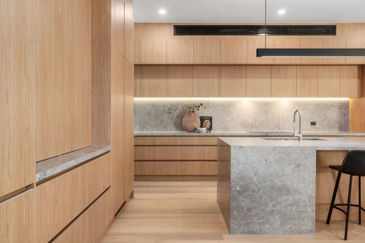 Soft-toned living room renovation with wooden flooring and large windows