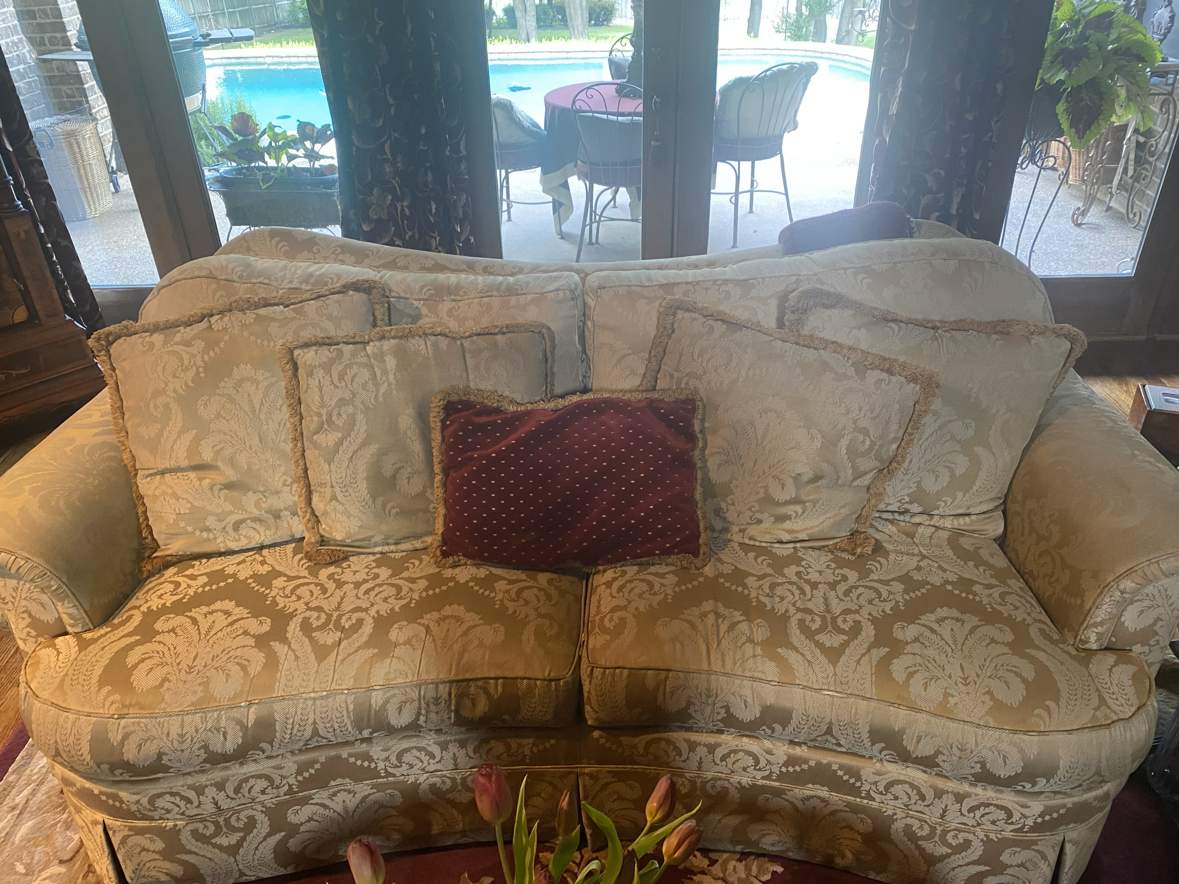 Before: worn couch with stains and sagging cushions