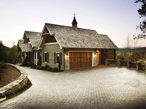 Elegant cedar roof on a rustic house set against an evening sky, representing long-lasting roofing material