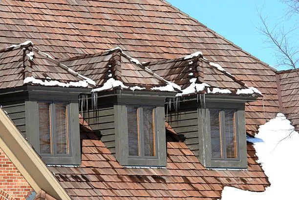Snow-covered cedar shake roofing showcasing energy efficiency