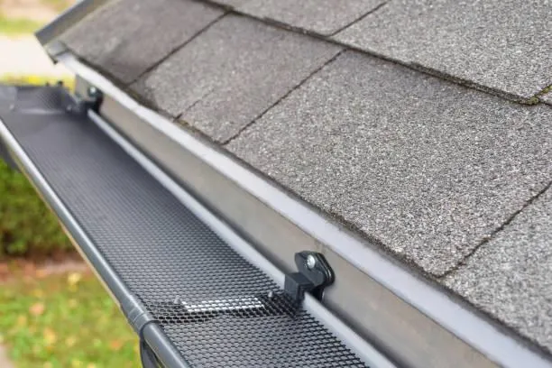 Close-up view of a new eavestrough system installed on a house, showcasing the durable materials used by Home Star Roofing for rainwater management.