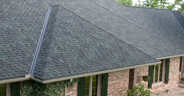 Close-up of a residential house with grey rubber roofing tiles installed by Home Star Roofing, highlighting the quality of work and roofing detail.