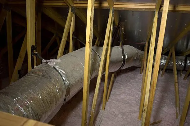 Interior view of an attic showing ductwork and framing, highlighting Home Star Roofing's ventilation services.