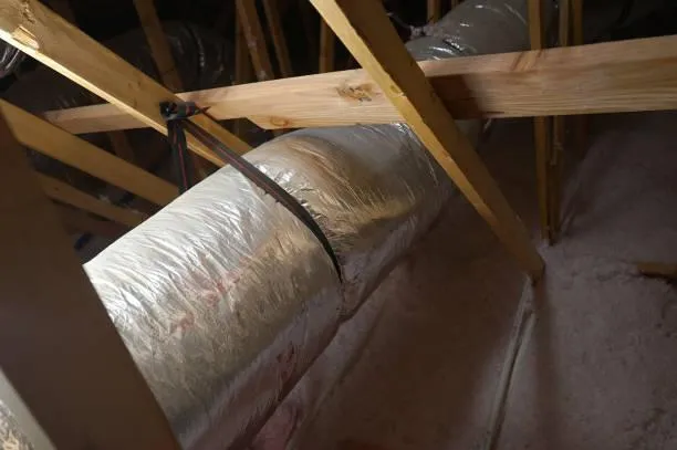 Insulated and sealed attic ducts, part of Home Star Roofing's comprehensive attic solutions for energy saving.