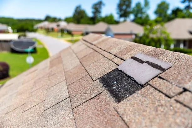 Close-up of a shingle roof with a patch repair, representing Home Star Roofing's repair services.