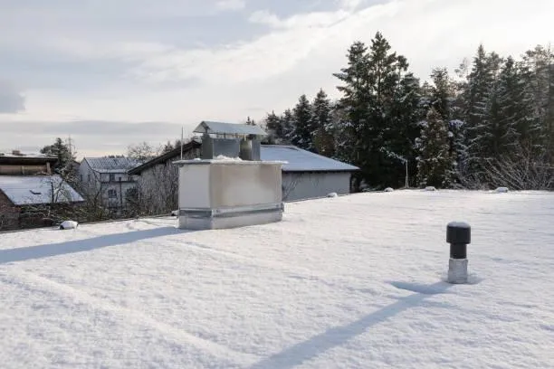 View of a flat roof after snow removal, illustrating the clear, protected surface maintained by Home Star Roofing's services.