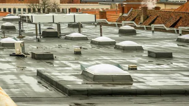 View of multiple skylights on a commercial building's flat roof, showcasing Home Star Roofing's installation work.