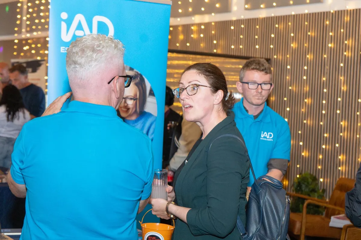 Exhibitors and guests talking at a stand at UK Homes Network LIVE Leeds, September 2026