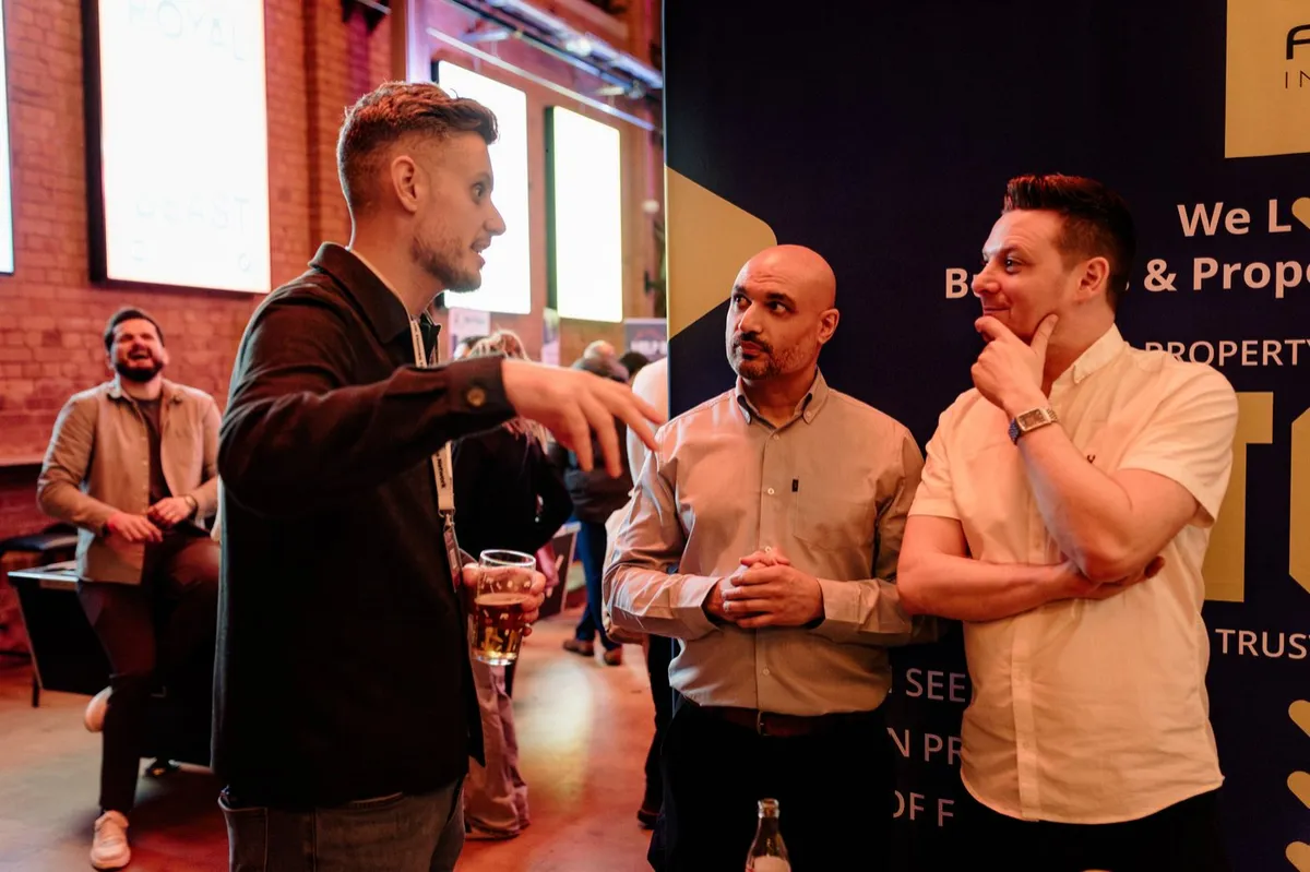 Guests talking at a stand at UK Homes Network LIVE Birmingham in the Indian Brewery taproom, February 2026