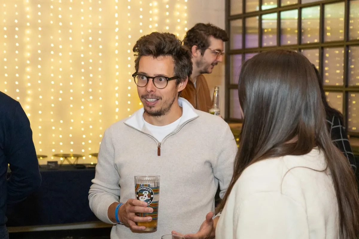 Guests talking over drinks under the festoon lights at UK Homes Network LIVE Leeds, Archive, September 2026