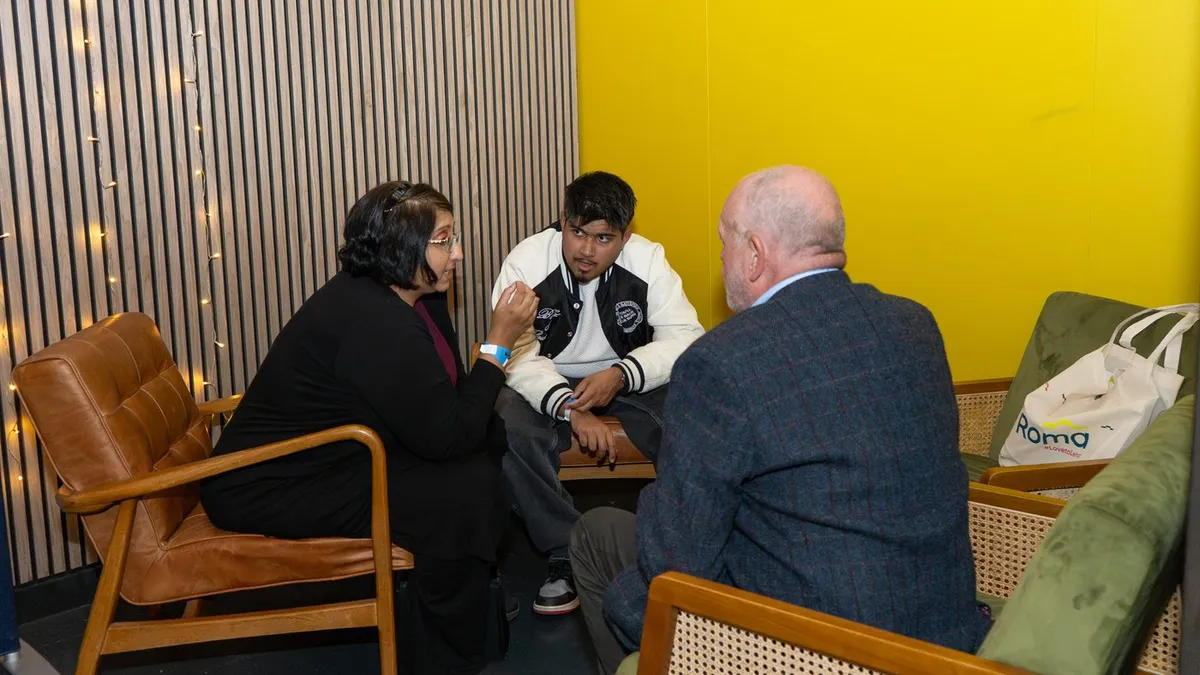 Three guests talking in the lounge area at UK Homes Network LIVE Leeds