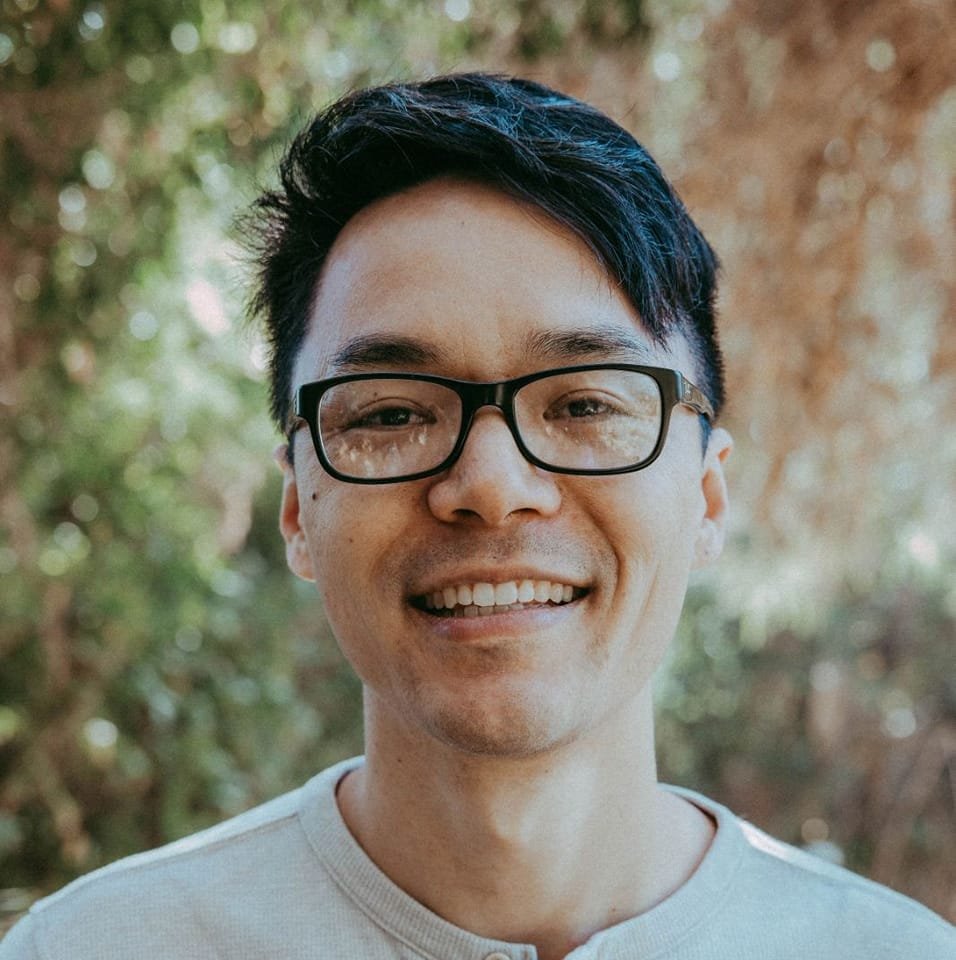 Modern living room with fireplace and forest view