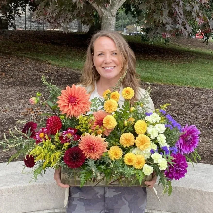 Floral designer of Efflorescence Floristry holding a seasonal bouquet in the New River Valley, reflecting a refined and thoughtful approach to floral design.
