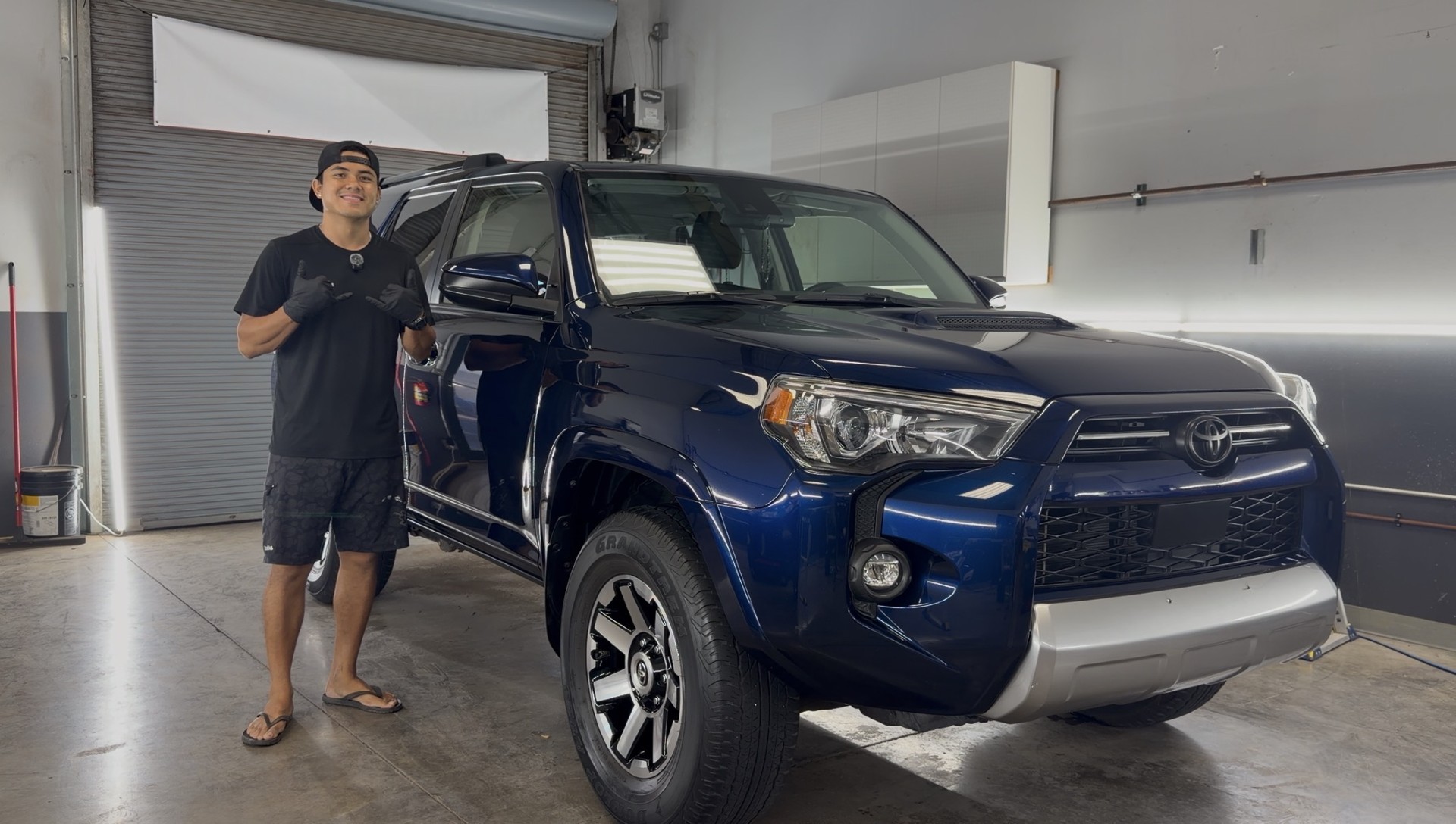 Justin beside a blue Toyota 4Runner at Island Elite Detail in Kihei.