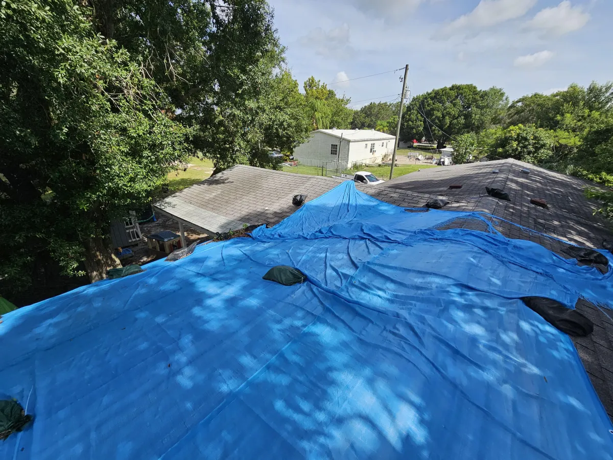 New asphalt shingle roof installation on Florida home with underlayment partially applied.
