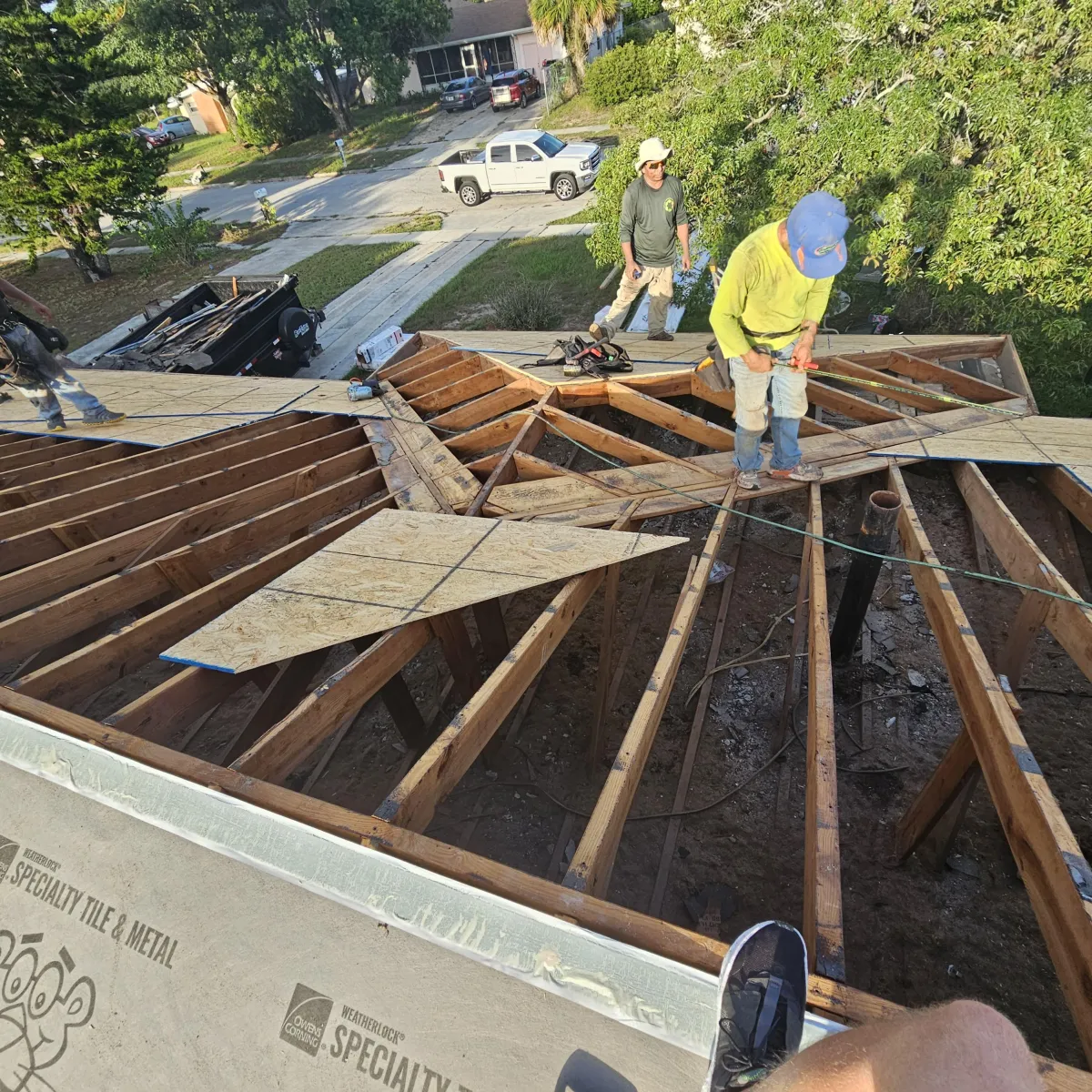 Licensed roof replacement contractors in Winter Haven FL installing new shingles and underlayment.