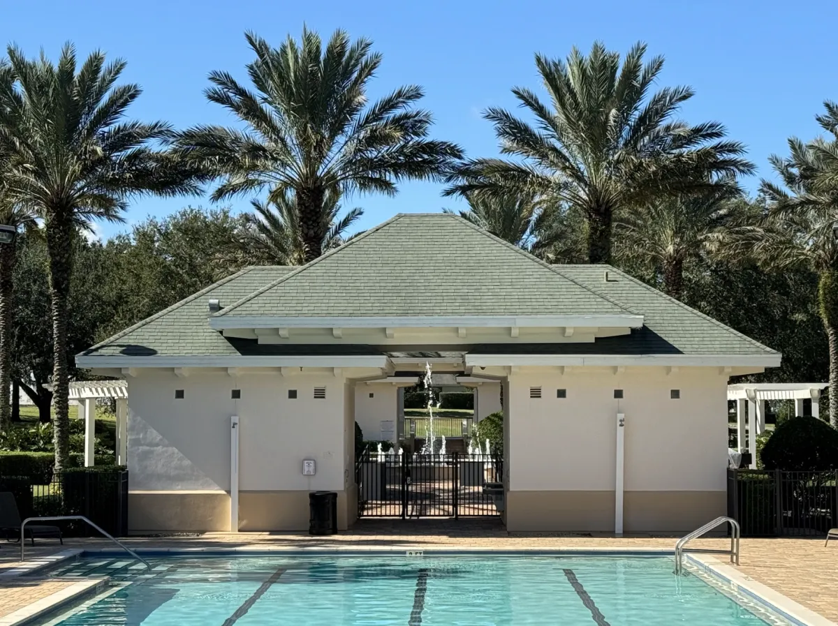 Clubhouse with new asphalt-shingle roof and palm trees in Winter Haven, FL.