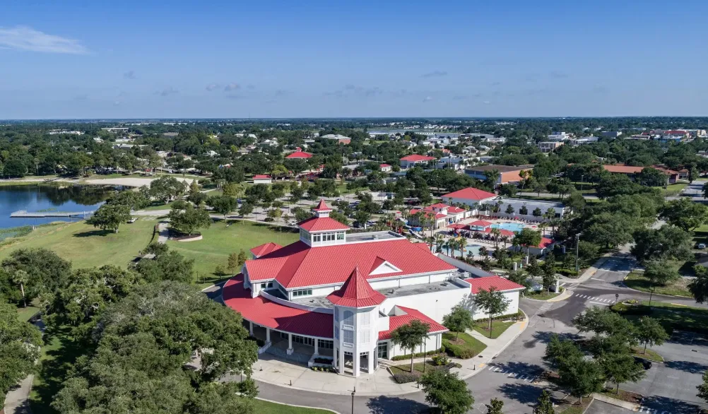 Aerial of Lake Eva Event Center with red roofs beside the park and lake in Haines City