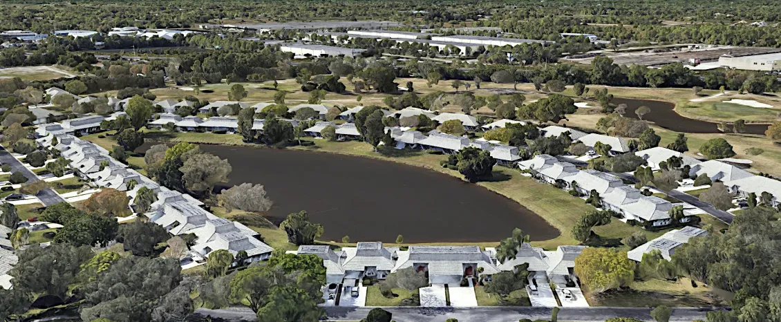 Aerial of homes and trees surrounding a small lake in Eagle Lake, Florida