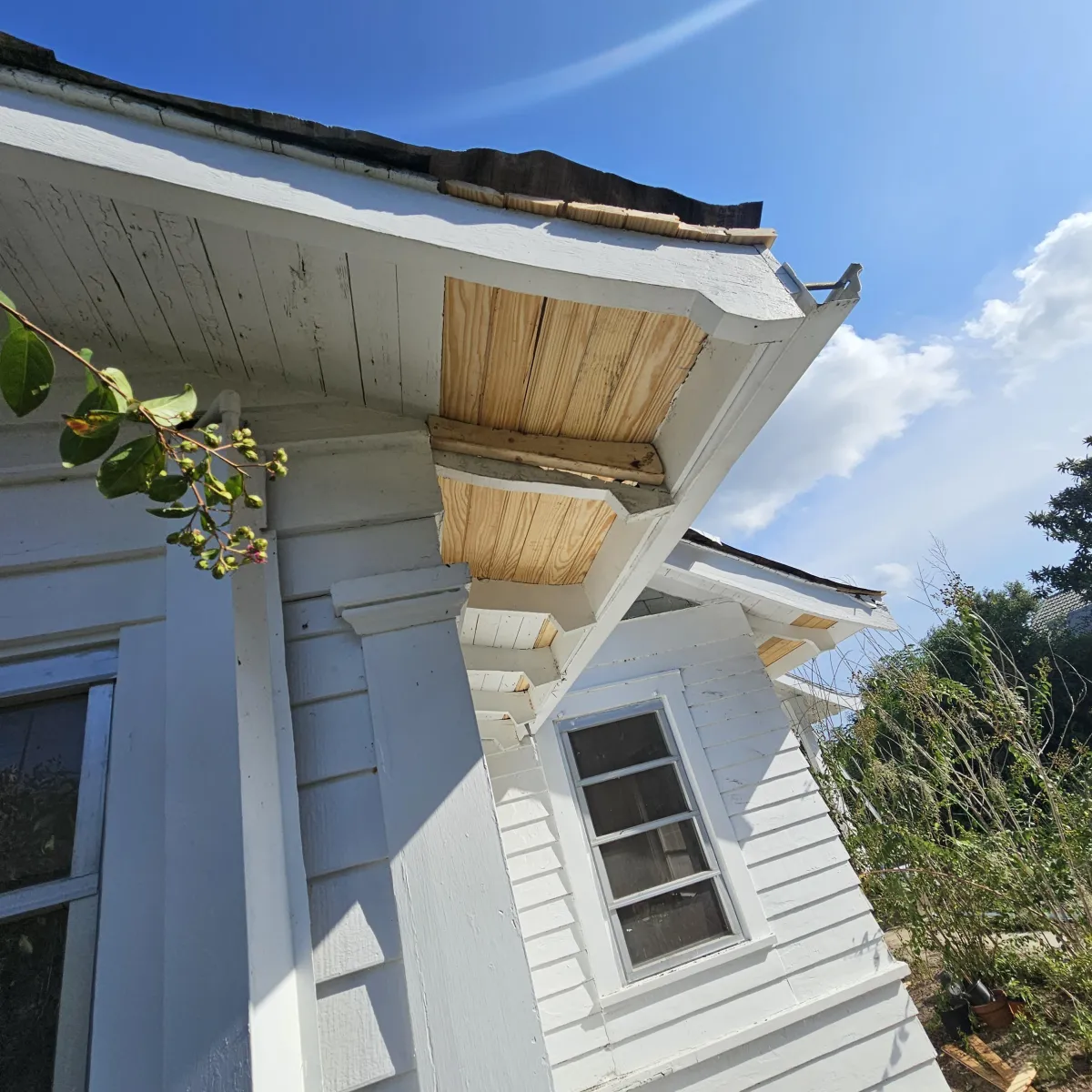Water-damaged soffit and fascia under the eave—common source of roof leaks.