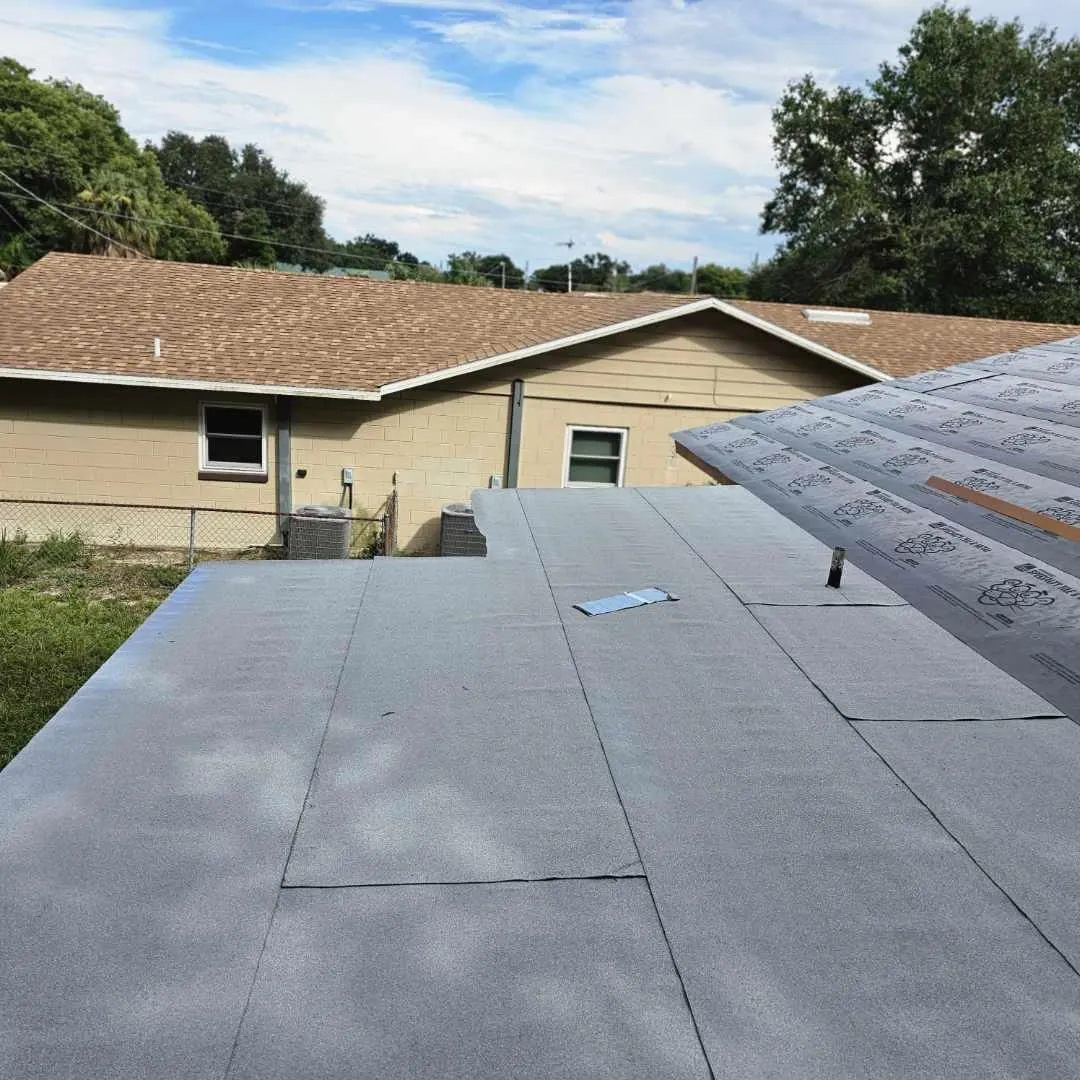 Modified bitumen cap sheet being installed on a low-slope roof.