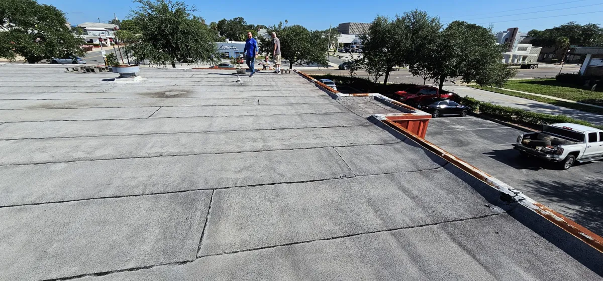 Large commercial flat roof with finished seams and edge metal.