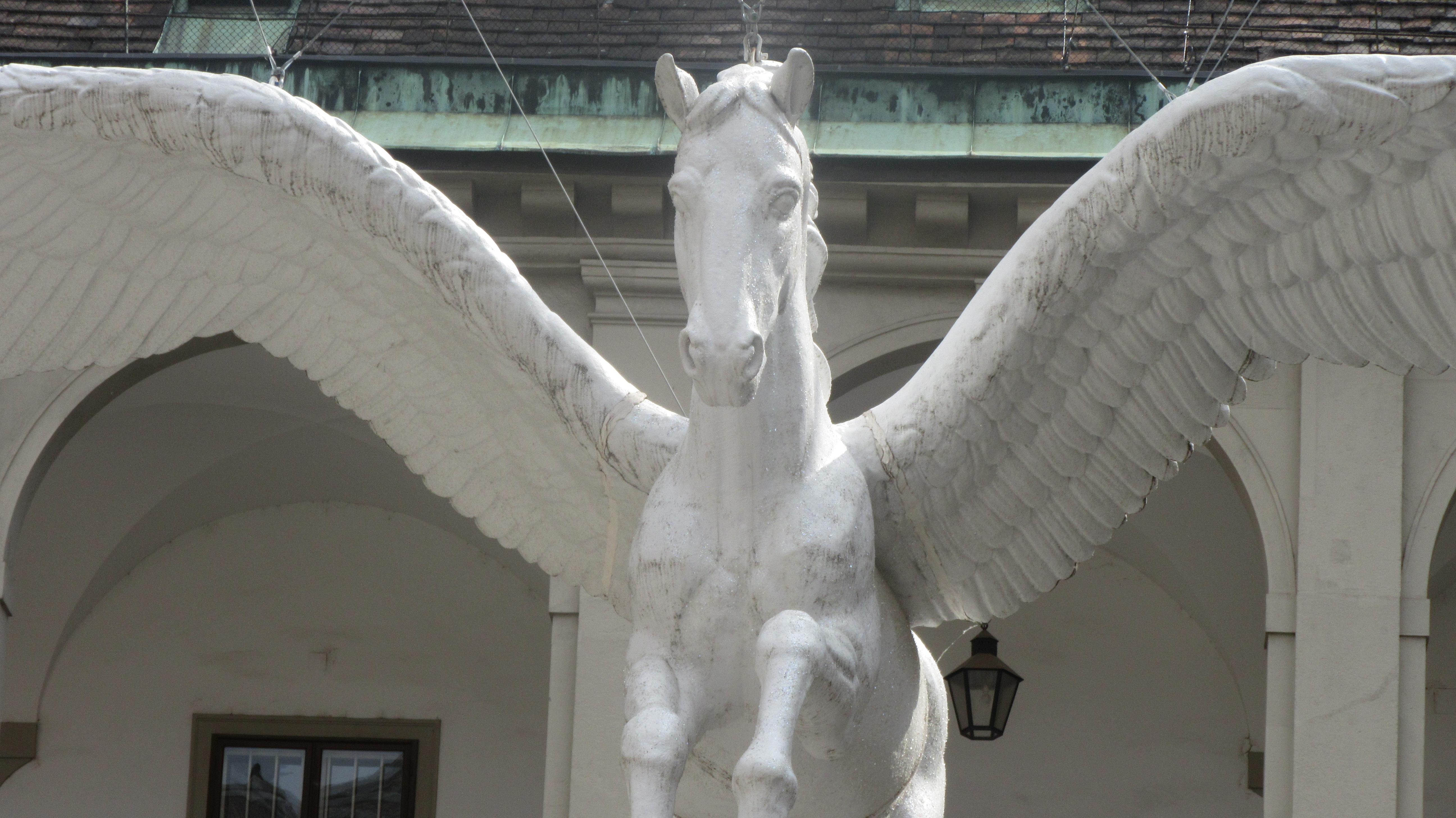 A hanging statue of a winged horse.
