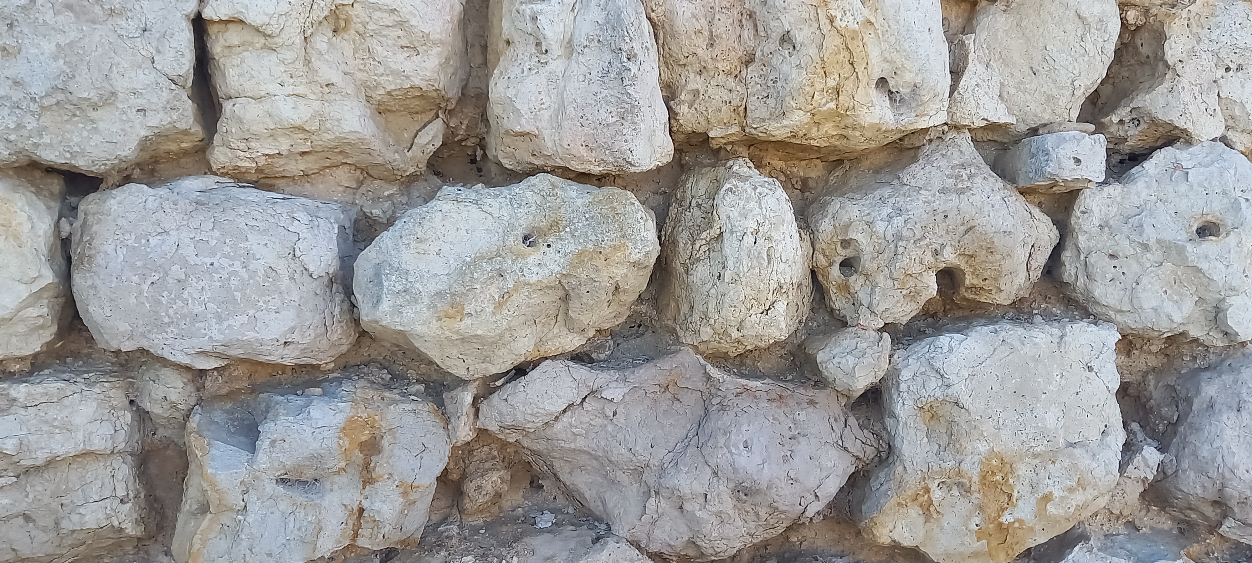 A close up of an old stone boundary wall.
